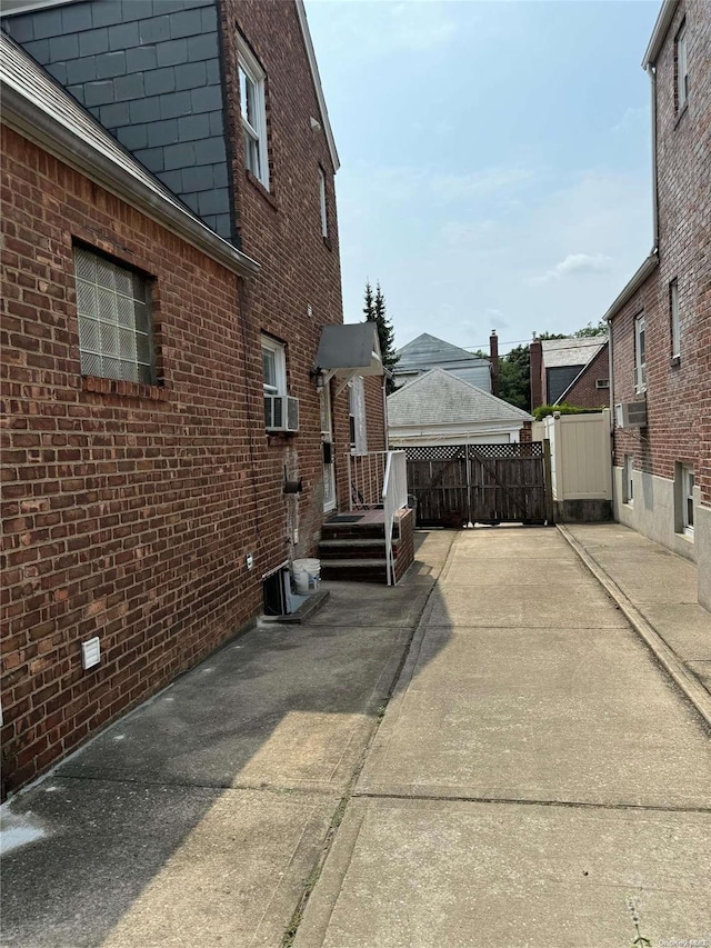 view of side of property featuring cooling unit and a patio