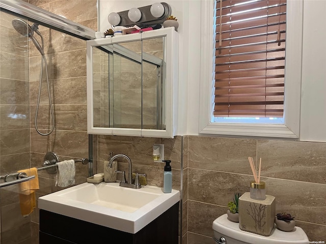 bathroom with vanity, toilet, backsplash, and tile walls