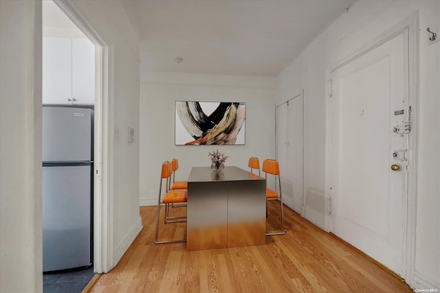 dining space featuring light wood-style floors