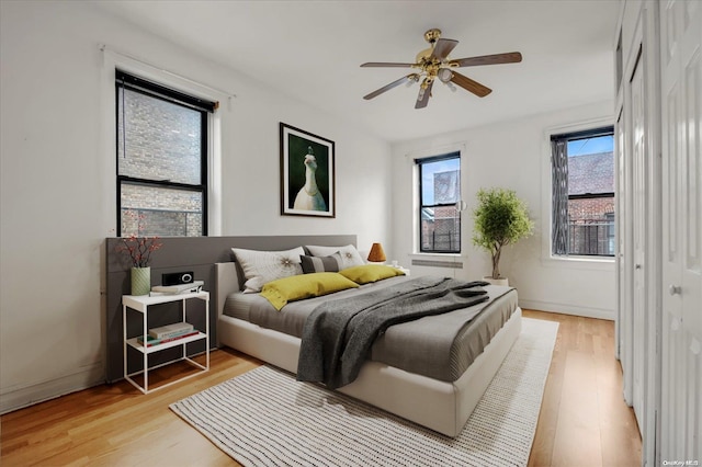 bedroom with light wood finished floors and ceiling fan