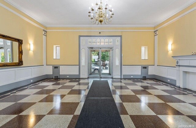 65-38 Booth St Unit 2F, Rego Park, NY 11374 - common area featuring wainscoting, a decorative wall, and ornamental molding