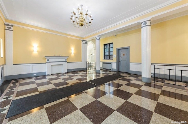 interior space featuring ornate columns, a chandelier, and ornamental molding