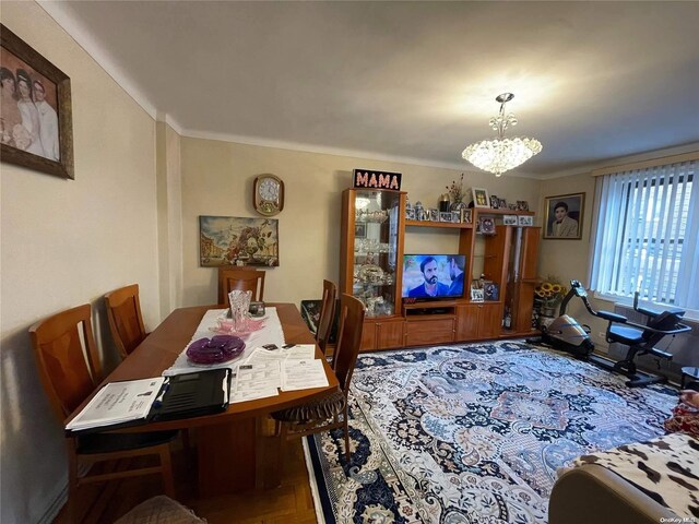 65-38 Booth St Unit 2F, Rego Park, NY 11374 - dining area with a chandelier and crown molding