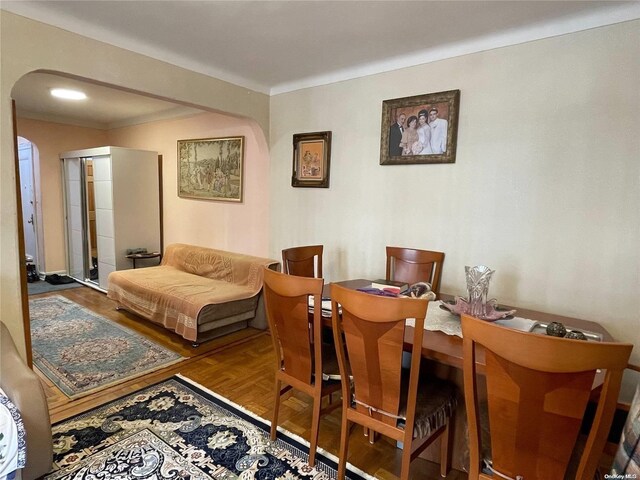 65-38 Booth St Unit 2F, Rego Park, NY 11374 - dining space with arched walkways and wood finished floors