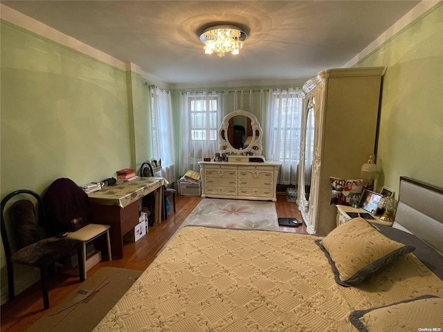 65-38 Booth St Unit 2F, Rego Park, NY 11374 - bedroom with wood finished floors and a chandelier