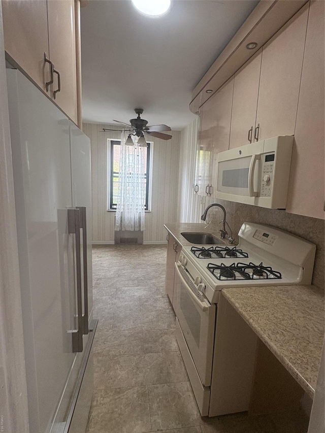 65-38 Booth St Unit 2F, Rego Park, NY 11374 - kitchen featuring white appliances, a sink, ceiling fan, and light countertops