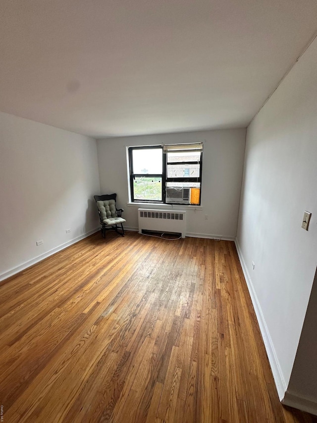 52-21 65th Pl Unit 6P, Maspeth, NY 11378 - unfurnished room with radiator, baseboards, and wood finished floors