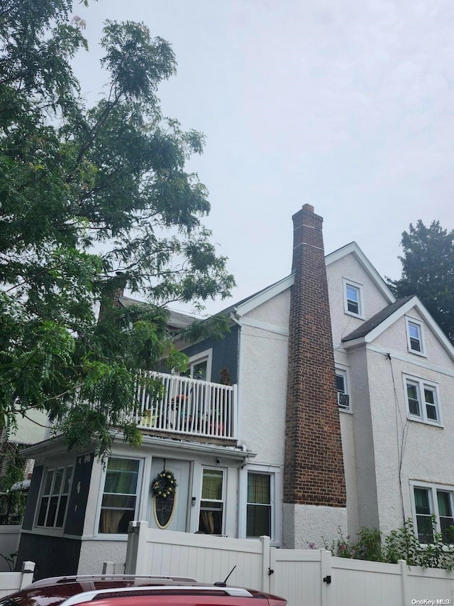 view of side of home with a balcony