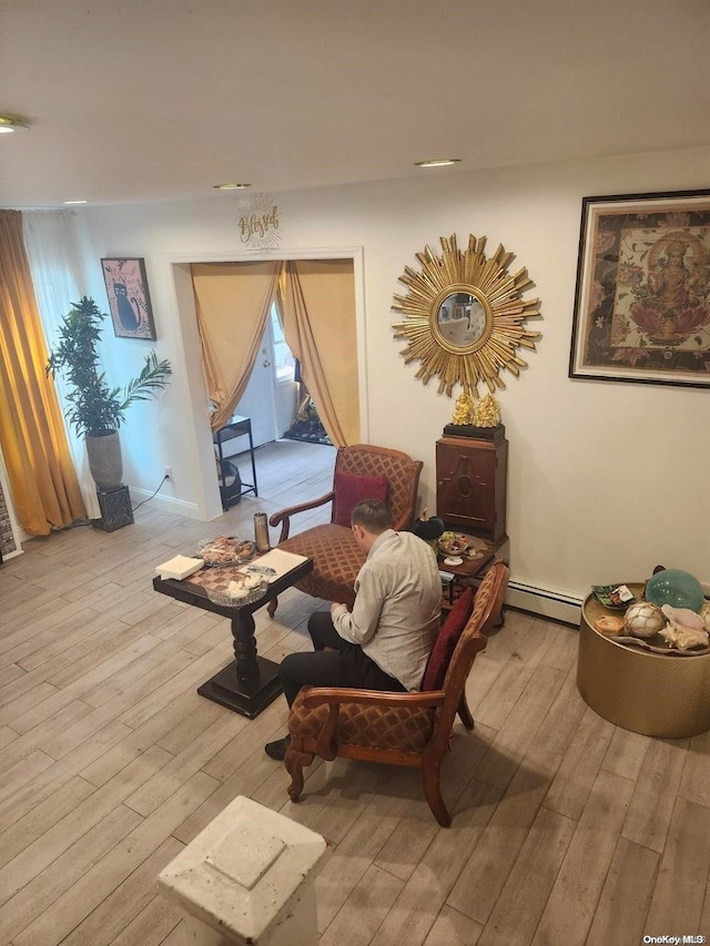 sitting room with light hardwood / wood-style flooring and a baseboard radiator