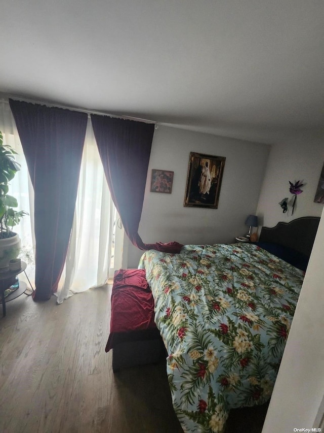 bedroom with hardwood / wood-style flooring