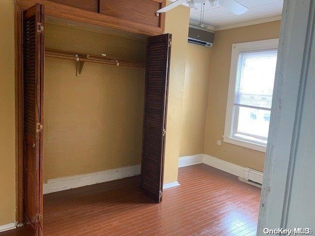 closet with a wall mounted air conditioner