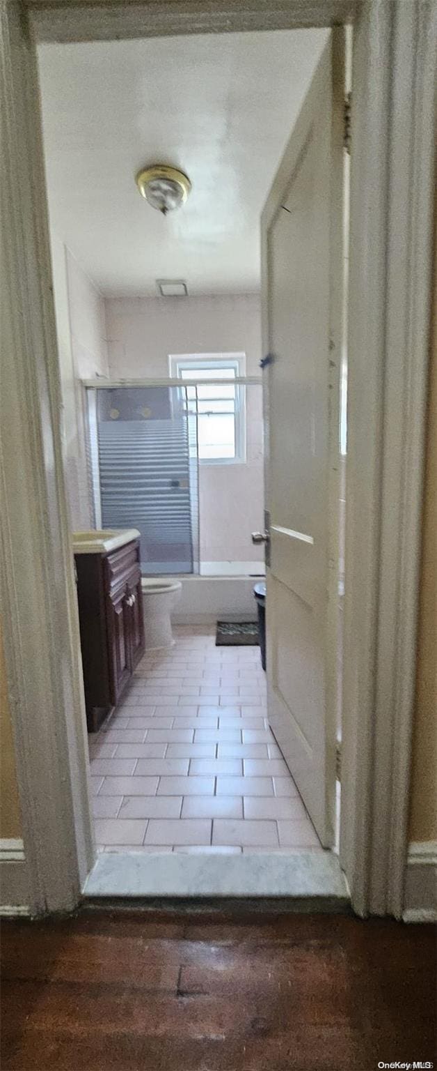 full bathroom featuring tile patterned flooring, vanity, washtub / shower combination, and toilet