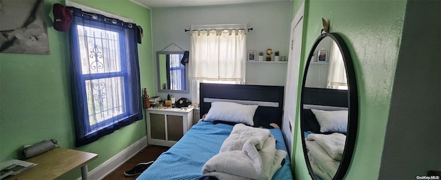 bedroom with dark hardwood / wood-style floors