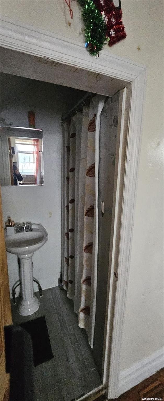 bathroom featuring sink and ornamental molding