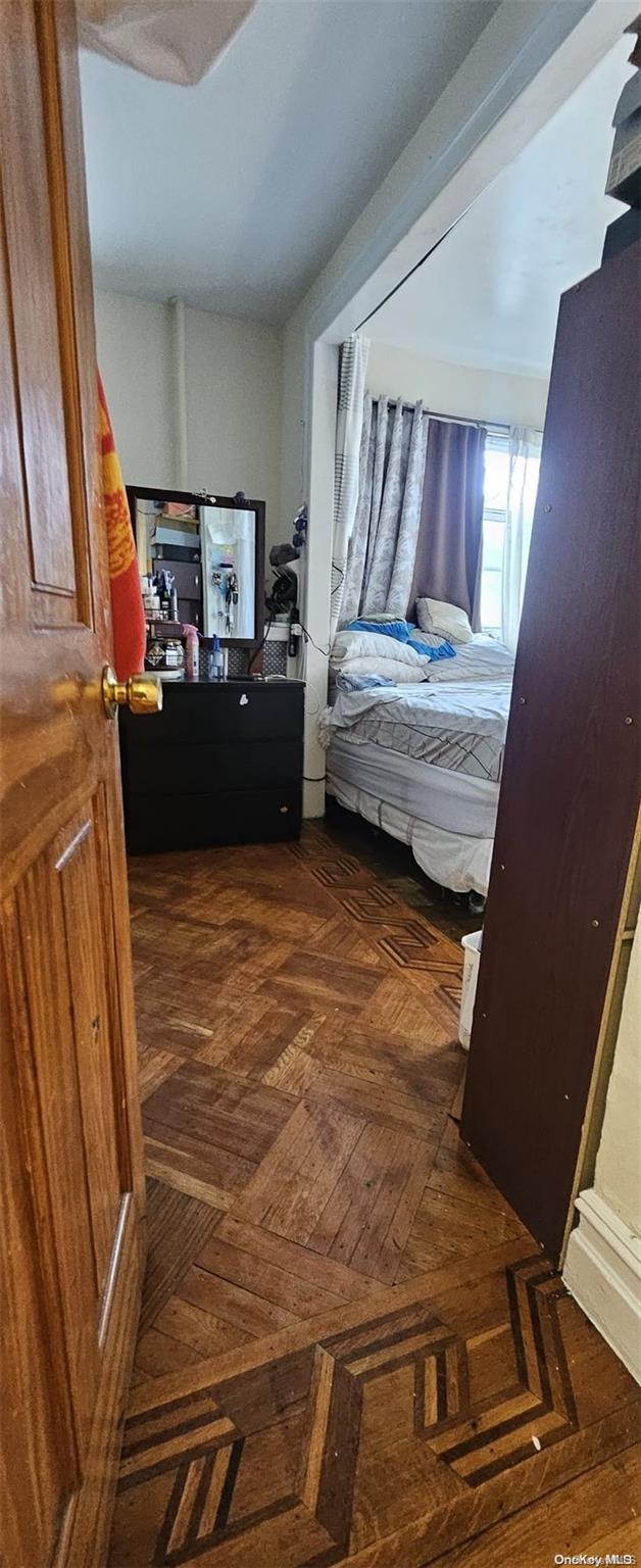 bedroom with dark parquet flooring