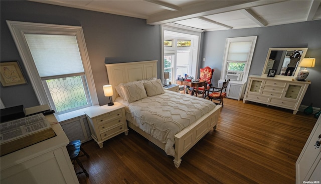 bedroom featuring cooling unit, radiator, beamed ceiling, and dark wood-type flooring