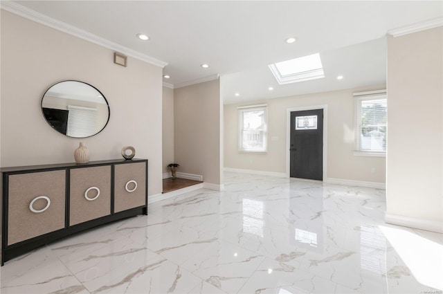 entrance foyer featuring a skylight, crown molding, and a healthy amount of sunlight