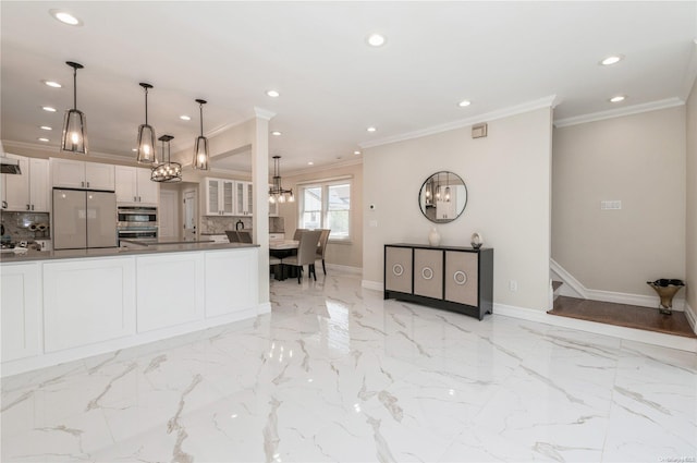 kitchen featuring backsplash, ornamental molding, white fridge, white cabinetry, and hanging light fixtures