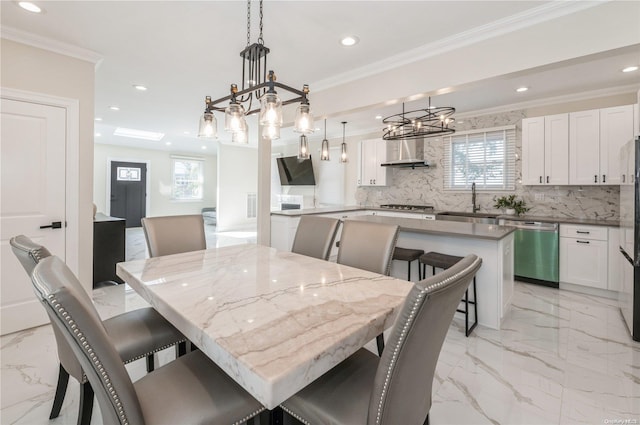 dining space featuring ornamental molding and sink