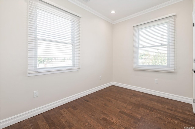 unfurnished room featuring ornamental molding and dark wood-type flooring