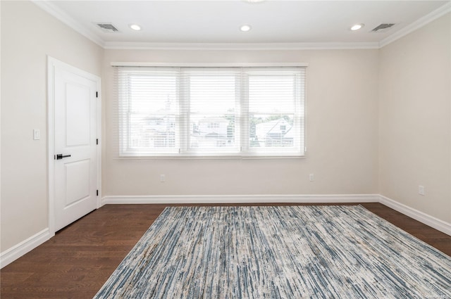 empty room with crown molding and dark wood-type flooring