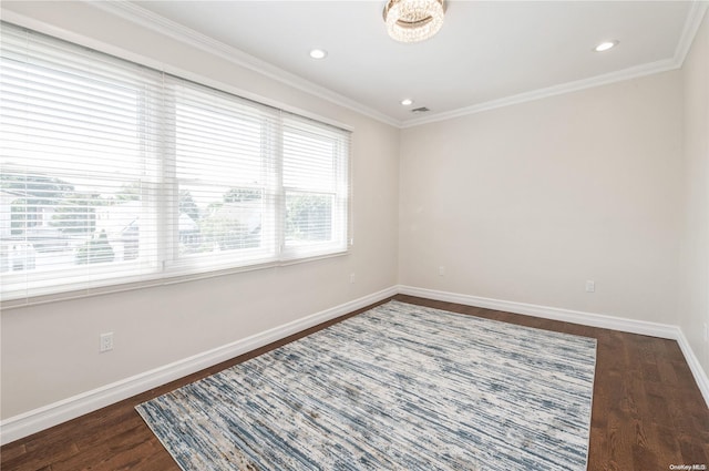 spare room featuring dark hardwood / wood-style floors and ornamental molding