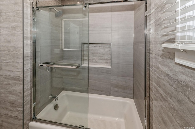 bathroom with shower / bath combination with glass door