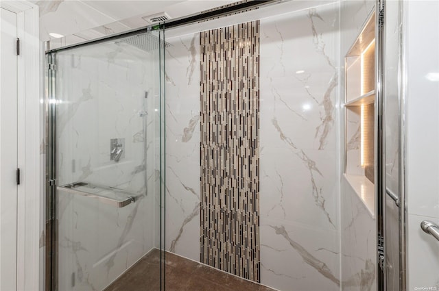 bathroom featuring a shower with shower door