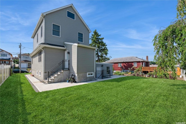 rear view of house featuring a lawn