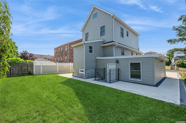 rear view of house featuring a yard and a patio area