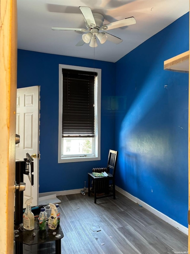 sitting room with ceiling fan and hardwood / wood-style floors