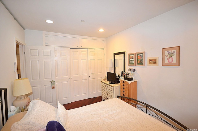 bedroom featuring dark hardwood / wood-style flooring and a closet