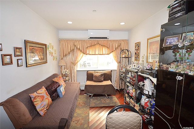 interior space with a wall mounted air conditioner, hardwood / wood-style flooring, and baseboard heating