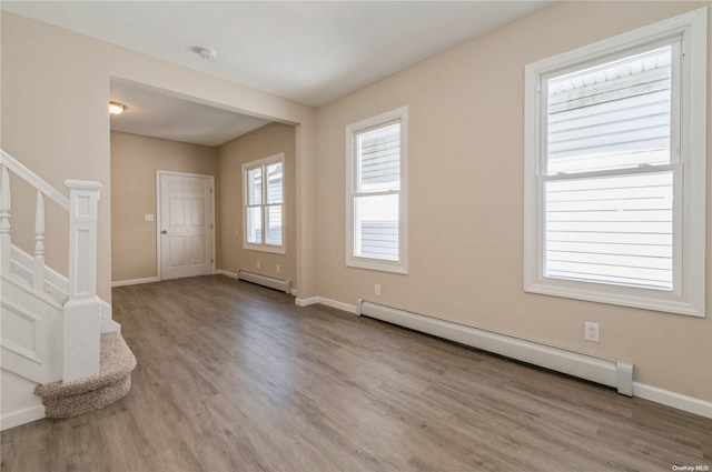 entryway with baseboard heating and light hardwood / wood-style floors