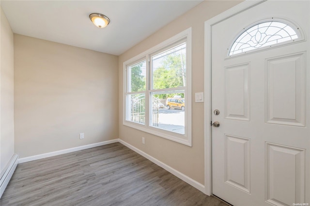 entrance foyer featuring light wood-type flooring and a baseboard radiator