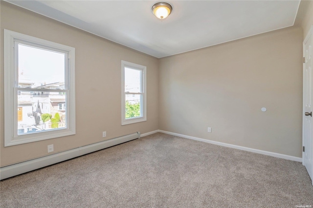 empty room with light colored carpet and baseboard heating