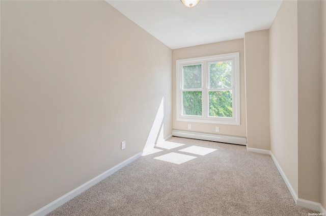 carpeted empty room featuring a baseboard radiator