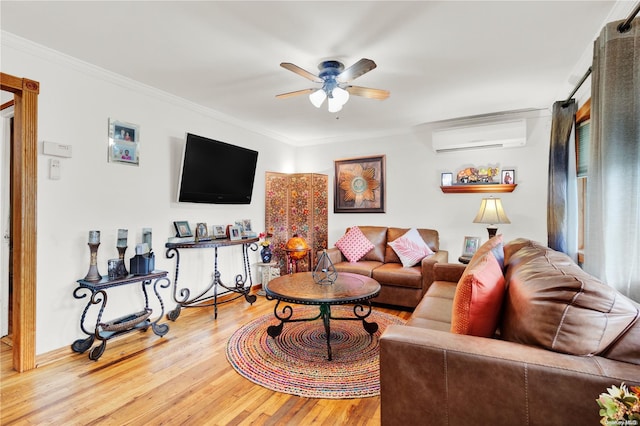 living room featuring an AC wall unit, ceiling fan, ornamental molding, and hardwood / wood-style flooring