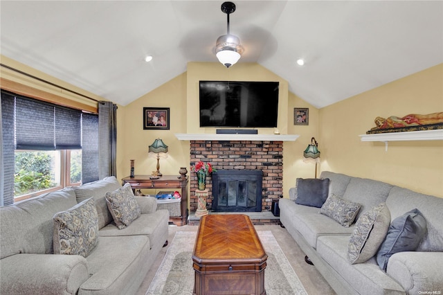 living room with vaulted ceiling and a brick fireplace