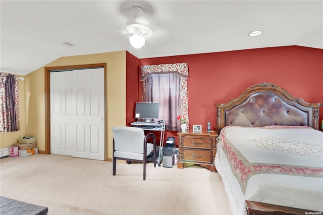 bedroom with ceiling fan, a closet, carpet floors, and vaulted ceiling