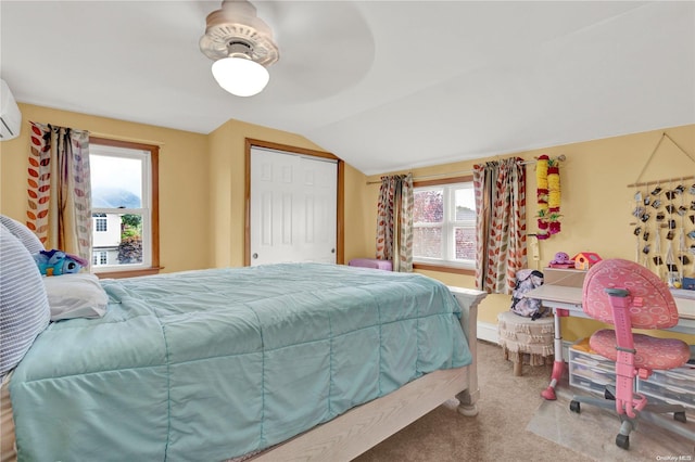 carpeted bedroom featuring a closet, vaulted ceiling, multiple windows, and ceiling fan