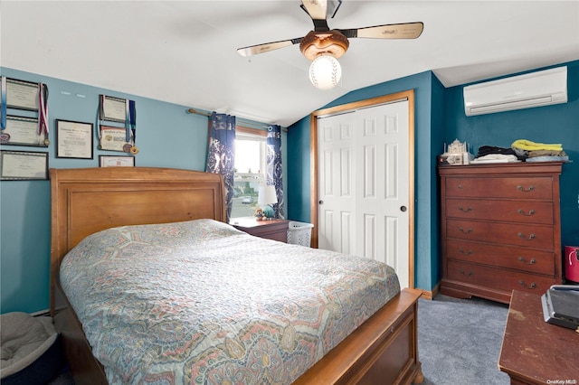 carpeted bedroom featuring ceiling fan, lofted ceiling, an AC wall unit, and a closet