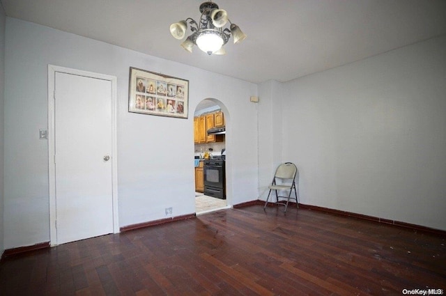 empty room with dark hardwood / wood-style floors