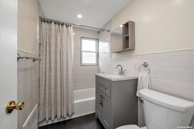 full bathroom with shower / bath combination with curtain, tasteful backsplash, vanity, tile walls, and toilet