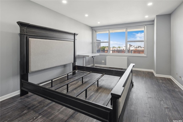 bedroom with dark hardwood / wood-style flooring