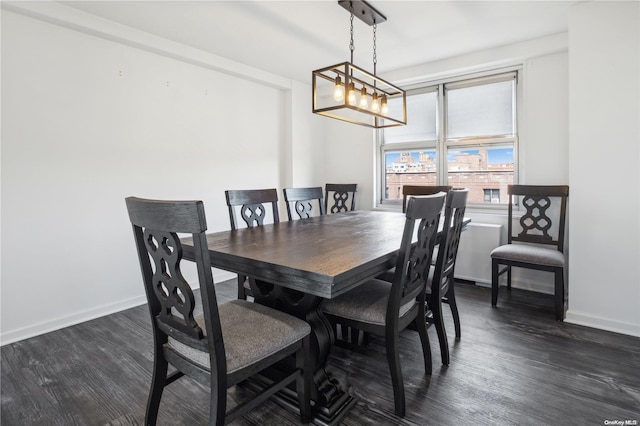 dining room with dark hardwood / wood-style flooring and an inviting chandelier