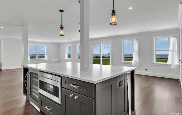 kitchen with dark hardwood / wood-style flooring, gray cabinets, and plenty of natural light