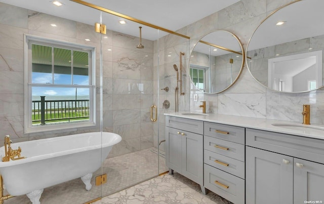 bathroom with vanity, separate shower and tub, and tile walls