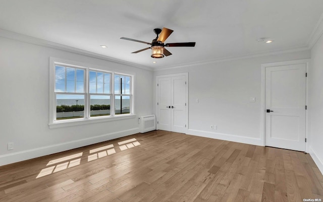 spare room with ceiling fan, light hardwood / wood-style floors, and ornamental molding