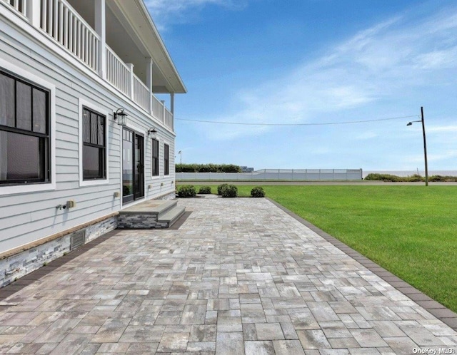 view of patio featuring a balcony